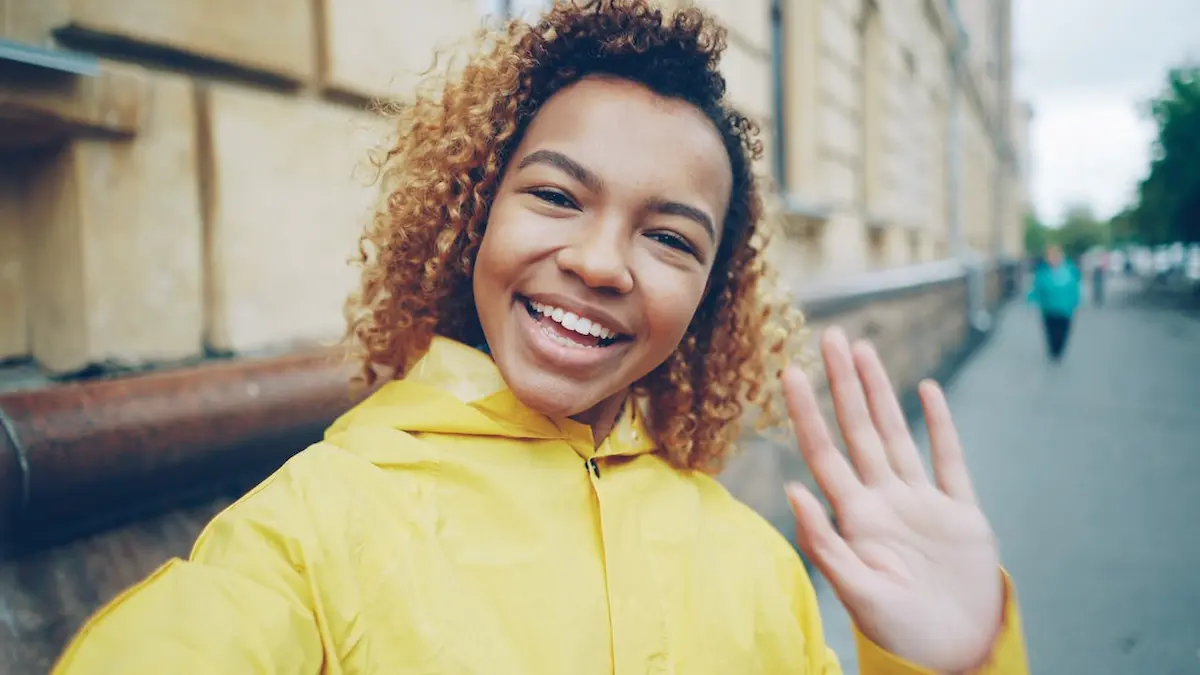 Cheerful Young Woman Smiling in Yellow Raincoat 1.00