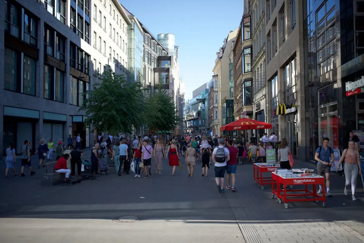 Busy People Walking on Street Between City Buildings 1.00