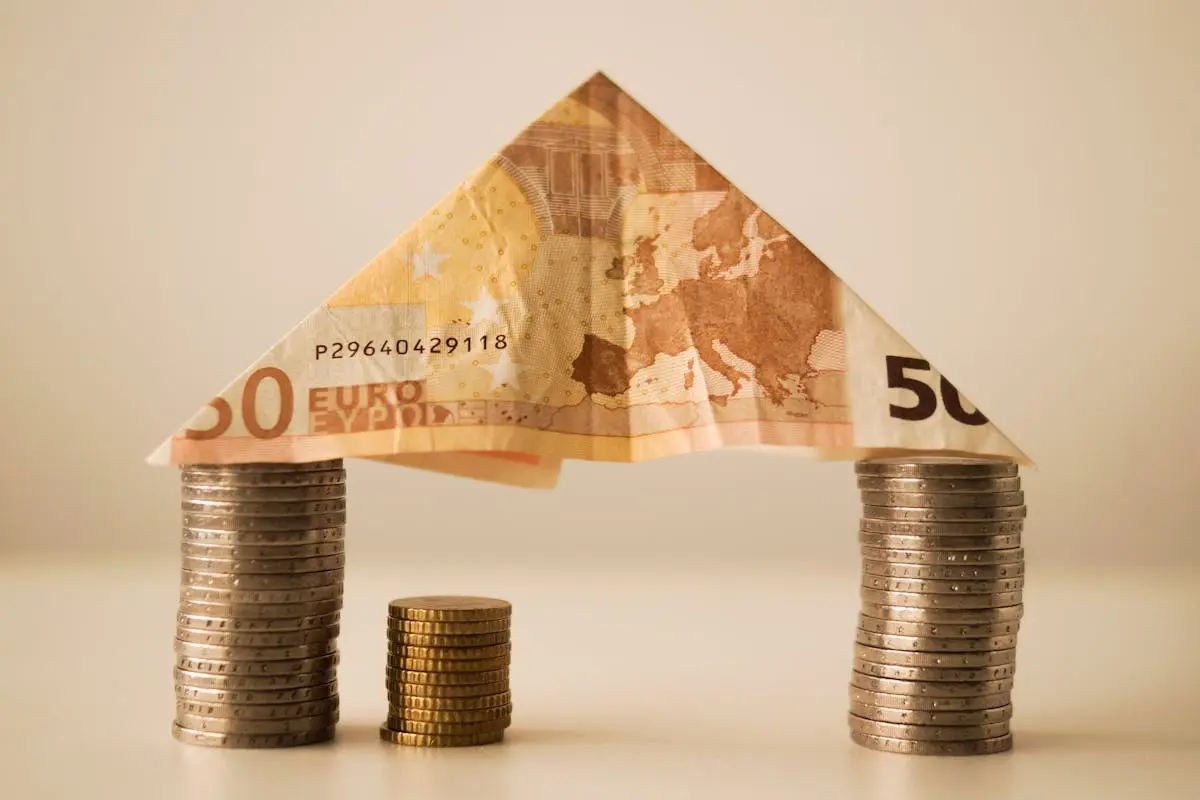 A creative composition using euro banknotes and coins to represent savings and financial structure. A creative composition using euro banknotes and coins to represent savings and financial structure.