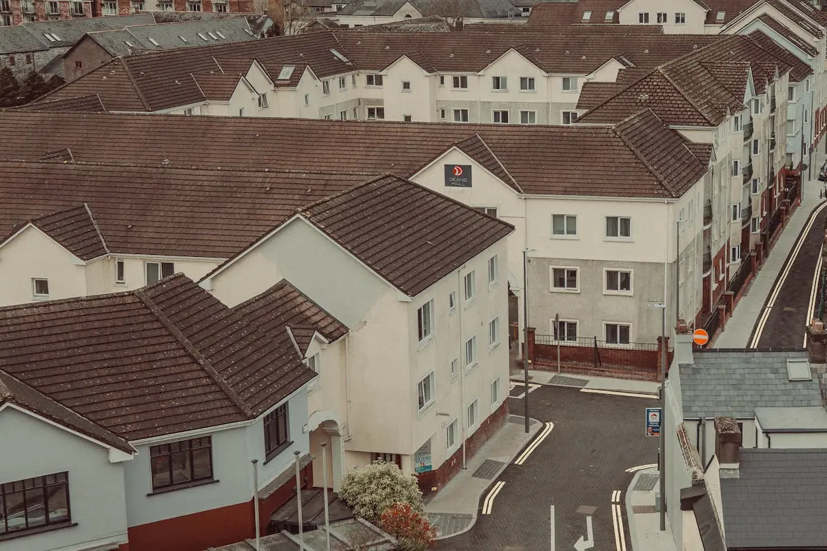 Aerial shot showcasing a dense housing complex with pitched roofs and narrow streets. Aerial shot showcasing a dense housing complex with pitched roofs and narrow streets.