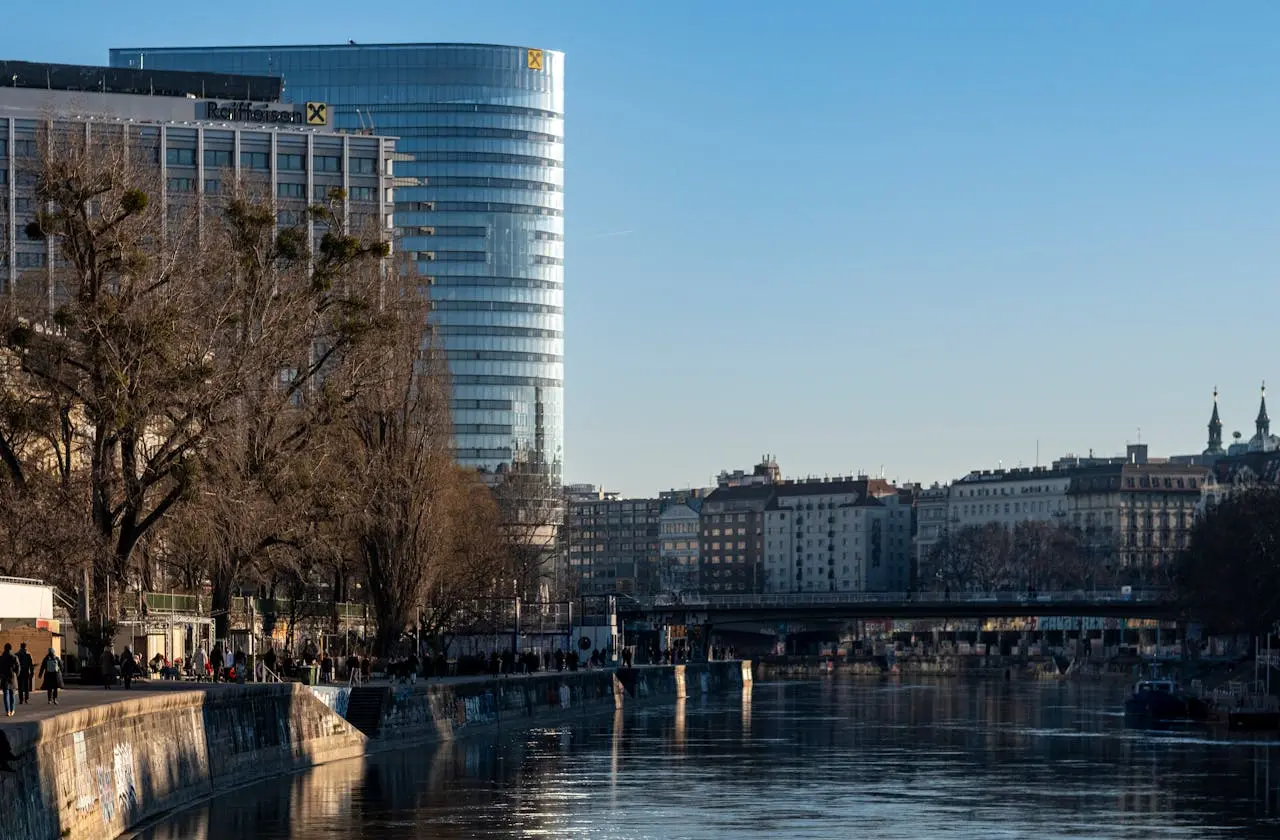 Urban landscape featuring artistic graffiti and modern architecture along the Danube Canal in Vienna. Urban landscape featuring artistic graffiti and modern architecture along the Danube Canal in Vienna.
