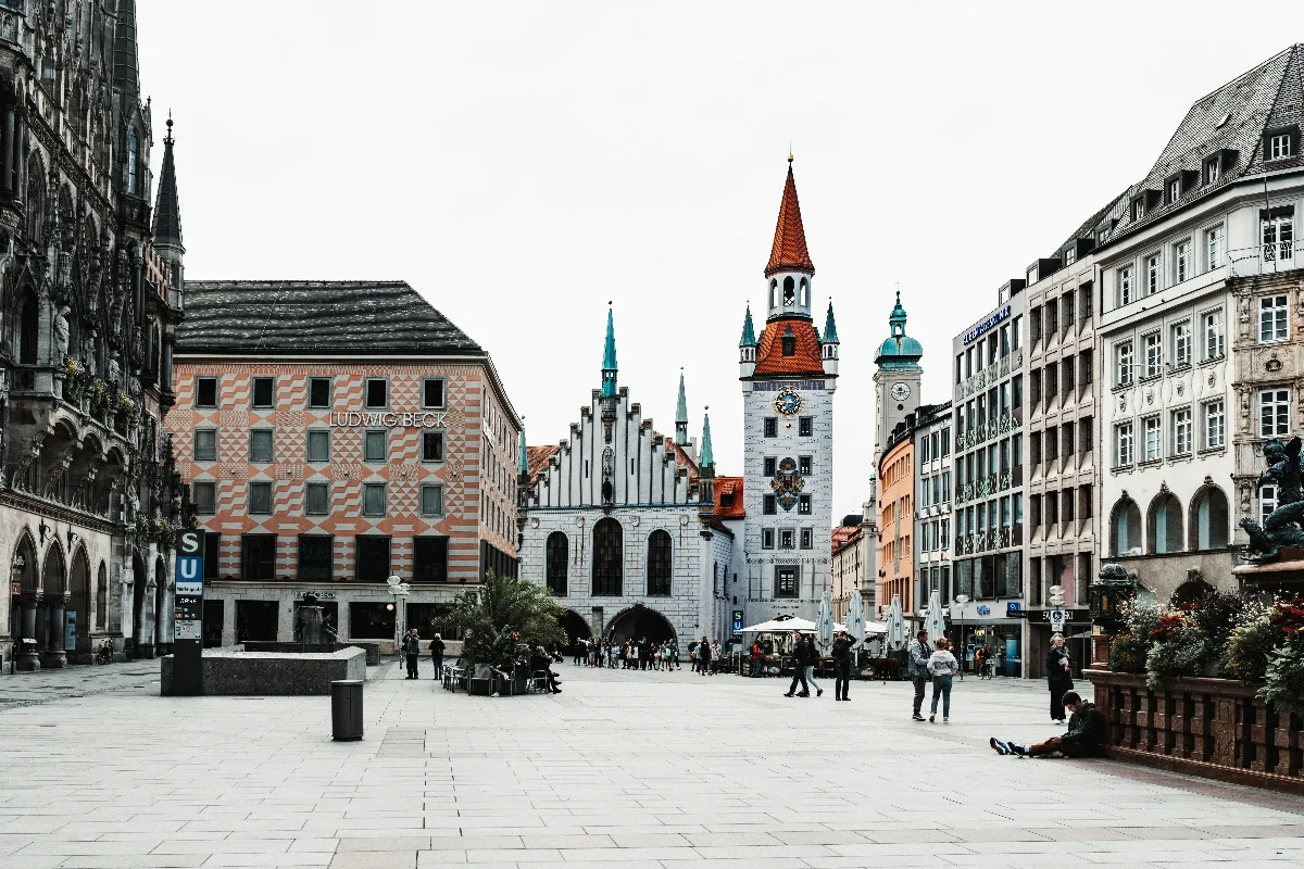 A bustling town square at Marienplatz, showcasing historic architecture in Munich, Germany. A bustling town square at Marienplatz, showcasing historic architecture in Munich, Germany.