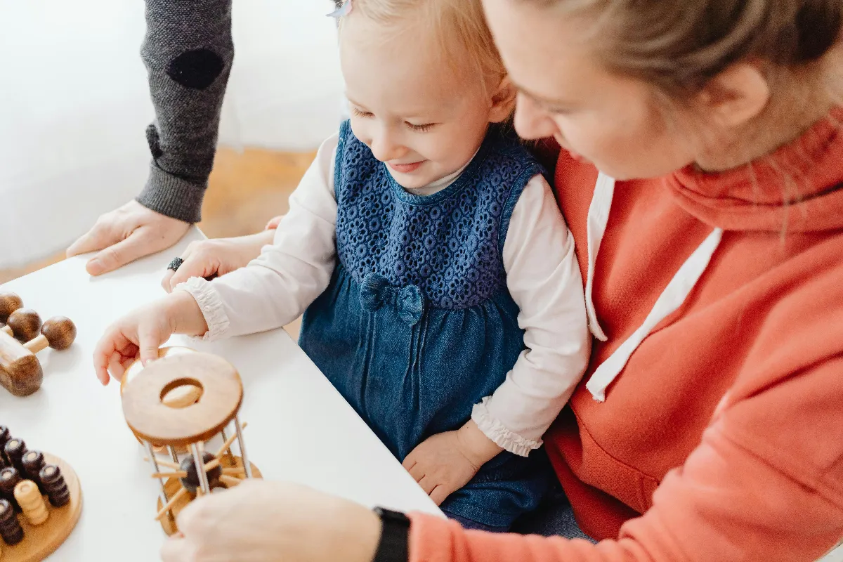 A mother and child engaging in playtime indoors with educational toys, fostering learning and bonding. A mother and child engaging in playtime indoors with educational toys, fostering learning and bonding.