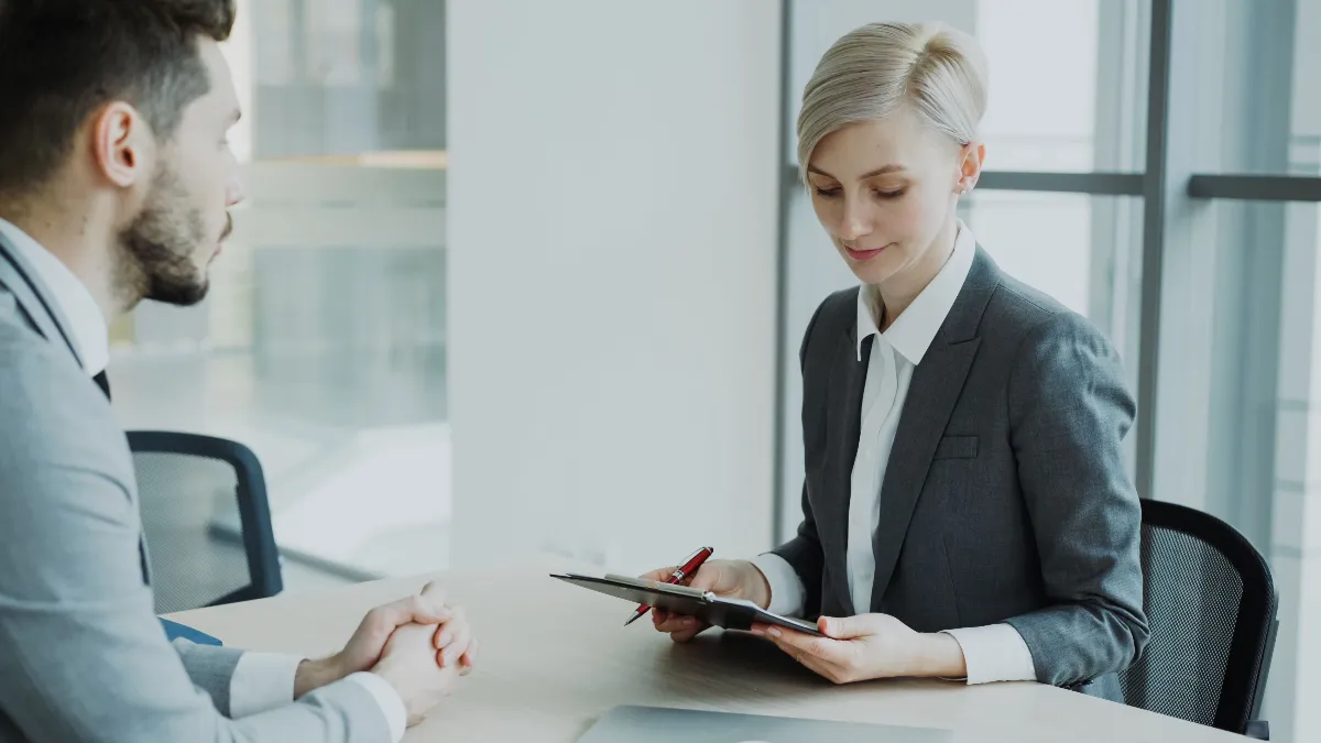 Two professionals in a modern office discussing business. Bright, professional setting. Two professionals in a modern office discussing business. Bright, professional setting.