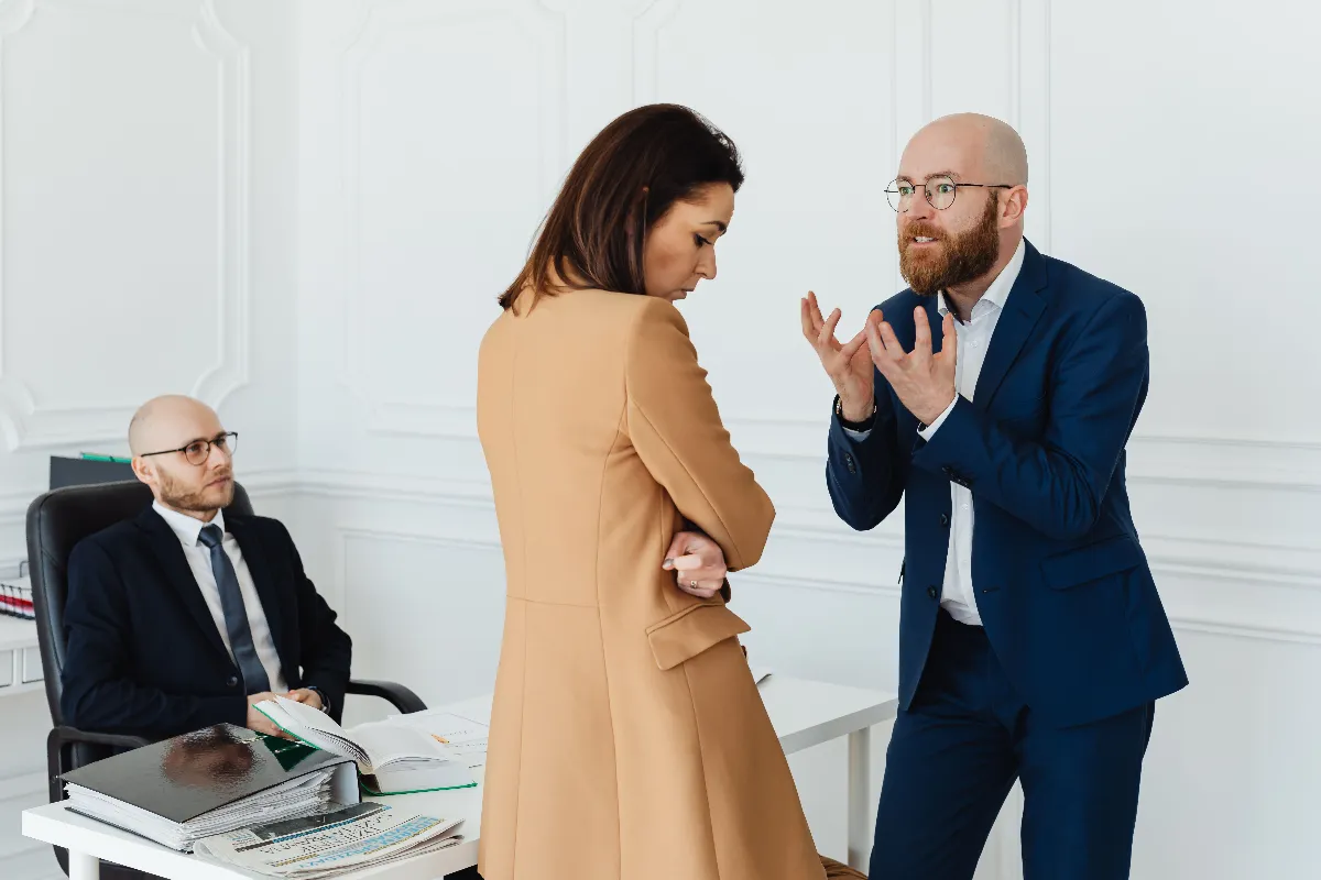 A group of business colleagues in a heated discussion at the office, showcasing workplace dynamics. A group of business colleagues in a heated discussion at the office, showcasing workplace dynamics.