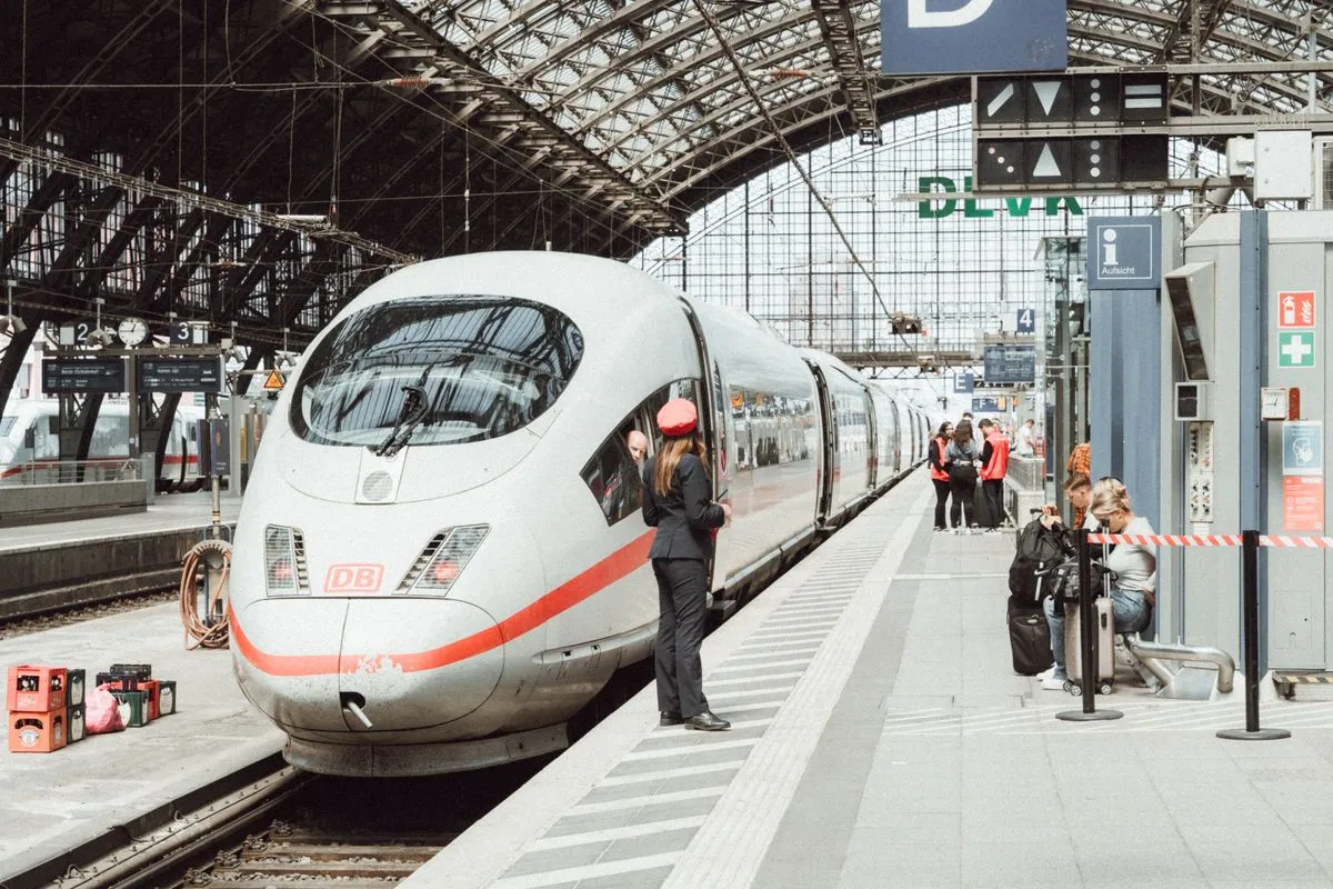 Passengers boarding a high-speed train at a modern German railway station. Passengers boarding a high-speed train at a modern German railway station.